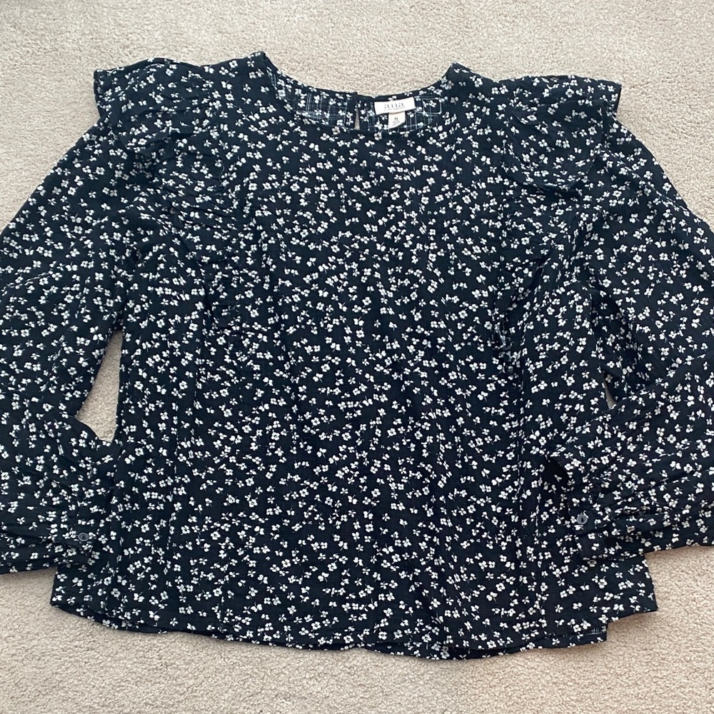 A New Approach a.n.a petite large black floral print top with ruffle details.
